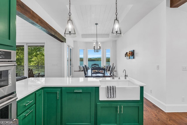 703 Cherokee Hls, Hiawassee, GA 30546 - kitchen with green cabinets, dark wood-style flooring, double oven, and a sink