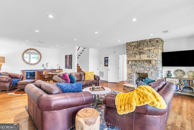 703 Cherokee Hls, Hiawassee, GA 30546 - living area with stairway, wood finished floors, visible vents, and a stone fireplace