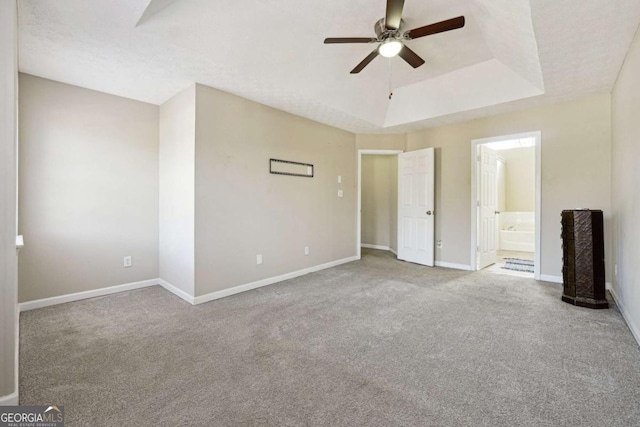 360 Wynbrook Dr, Mcdonough, GA 30253 - interior space with ceiling fan, baseboards, ensuite bathroom, carpet, and a tray ceiling