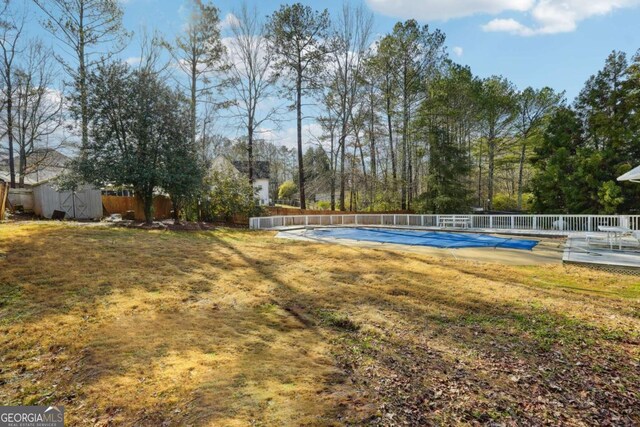 360 Wynbrook Dr, Mcdonough, GA 30253 - view of yard with fence, a fenced in pool, an outbuilding, and a shed