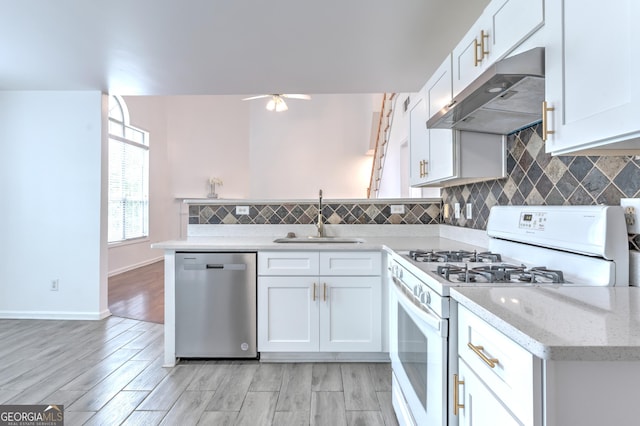 kitchen with a ceiling fan, dishwasher, a sink, white range with gas cooktop, and under cabinet range hood