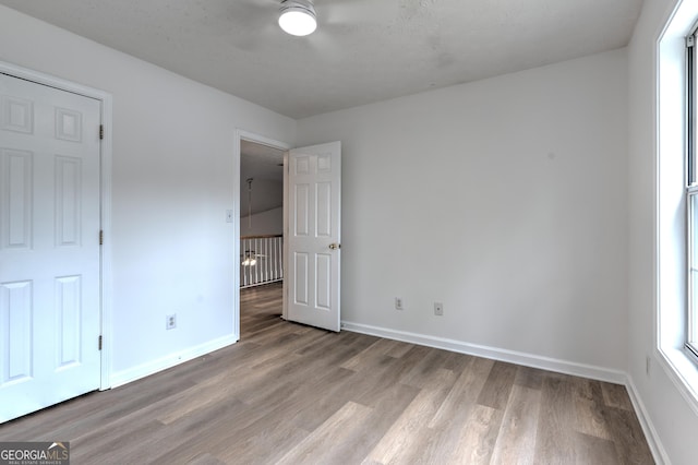 unfurnished bedroom featuring baseboards and light wood finished floors