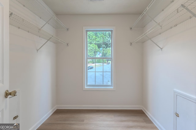 spacious closet featuring wood finished floors