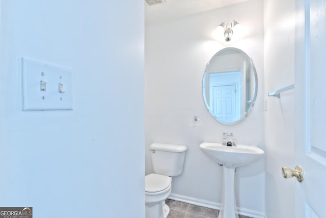 bathroom with tile patterned floors, baseboards, toilet, and visible vents