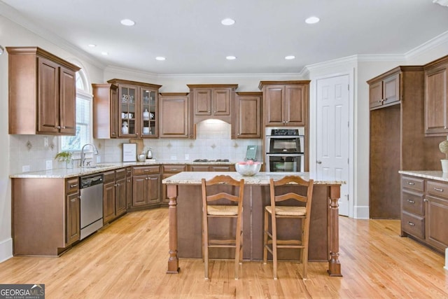 198 Grandmar Chase, Canton, GA 30115 - kitchen with appliances with stainless steel finishes, a sink, light wood-style floors, a kitchen island, and glass insert cabinets
