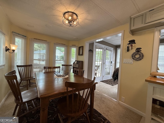 dining space featuring carpet floors and baseboards
