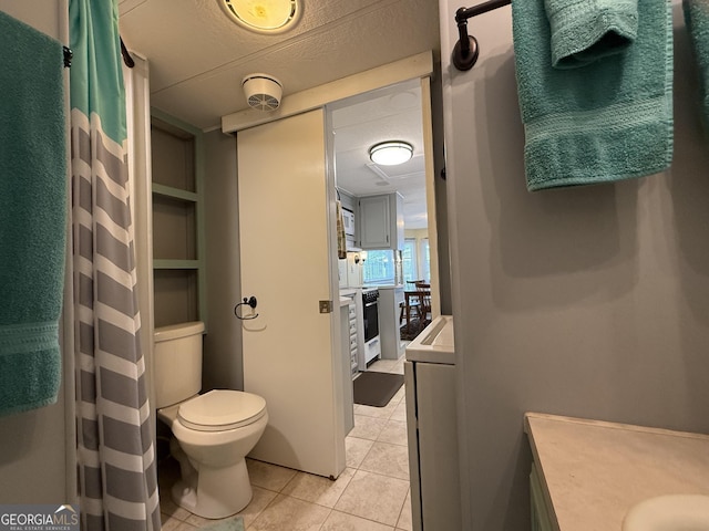 full bathroom featuring a shower with curtain, tile patterned floors, vanity, and toilet