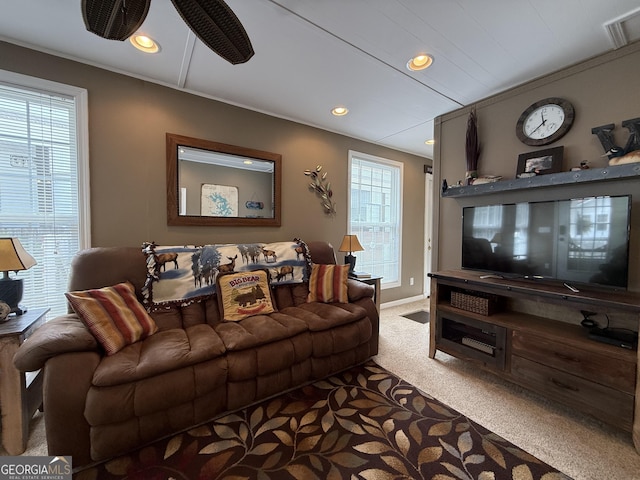 carpeted living room with visible vents, recessed lighting, baseboards, and crown molding
