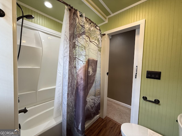 full bath with crown molding, shower / bathtub combination with curtain, wood finished floors, and toilet