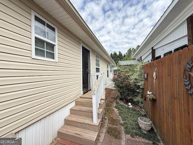 view of side of home with fence