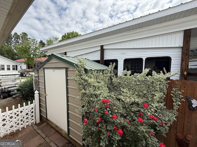 view of shed with fence