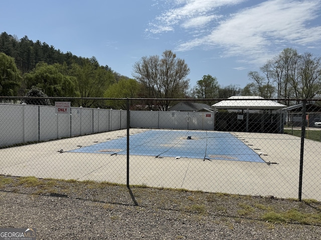 pool with a gazebo and fence