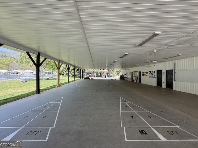 view of property's community with shuffleboard and a lawn