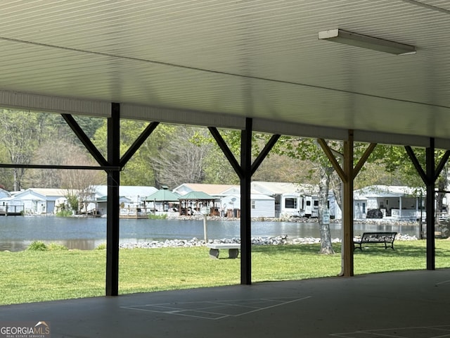 view of patio / terrace with a water view and a residential view