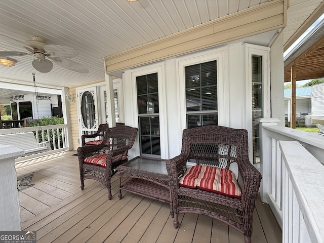 wooden terrace featuring ceiling fan