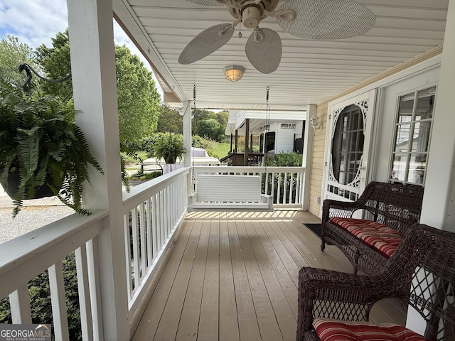 deck with covered porch and a ceiling fan