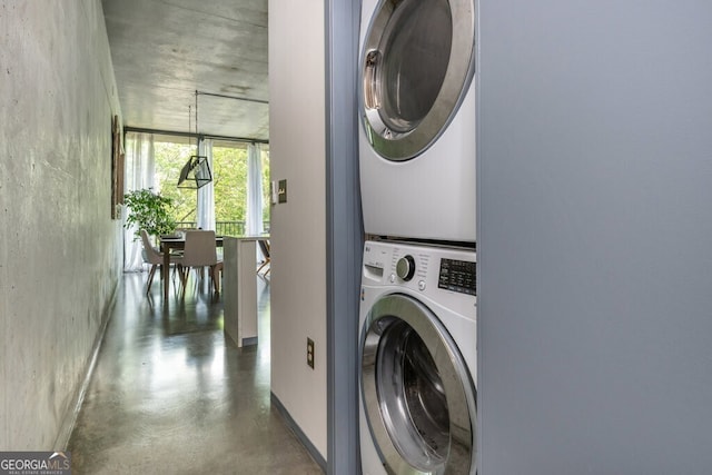 clothes washing area with stacked washer / drying machine and laundry area