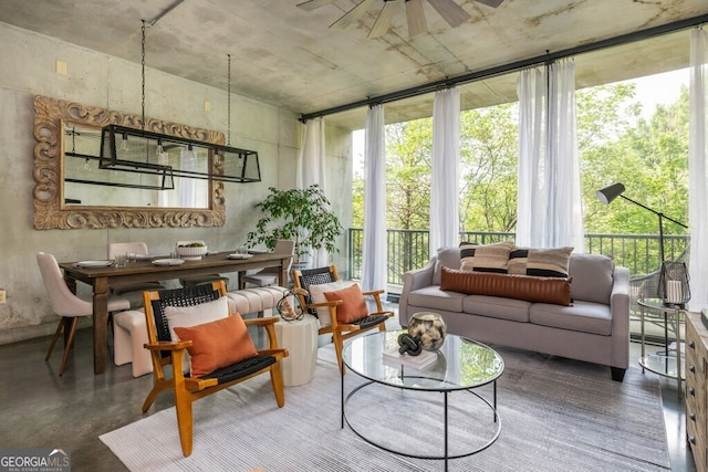 sunroom / solarium featuring finished concrete floors and a baseboard heating unit