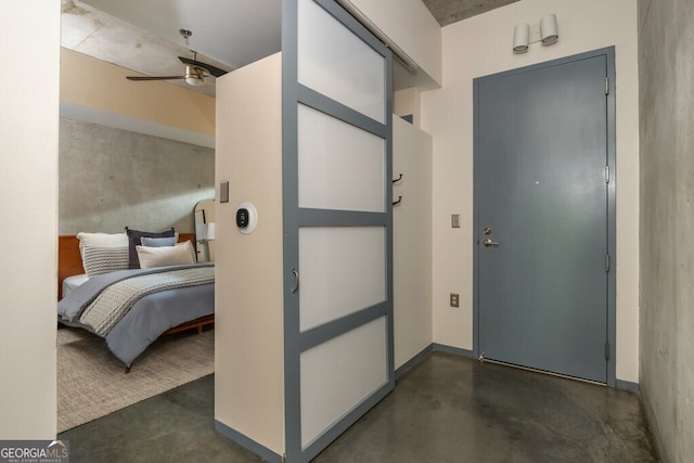 interior space with concrete flooring and ceiling fan
