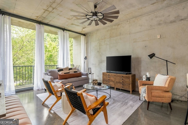 living room with finished concrete flooring and ceiling fan