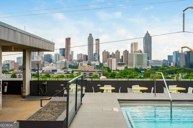 view of swimming pool with a view of city