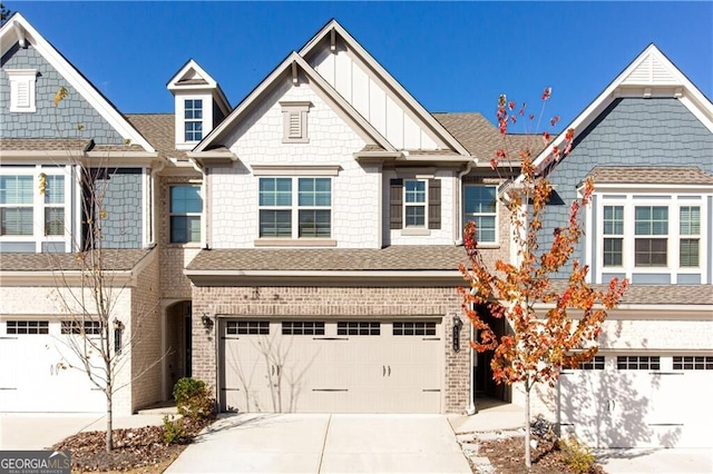 6348 Lanier Harbor Lndg, Buford, GA 30518 - townhome / multi-family property featuring an attached garage, concrete driveway, a shingled roof, and brick siding