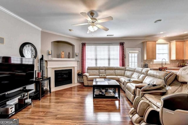 2695 Ridge Run Trl, Duluth, GA 30097 - living room with crown molding, a ceiling fan, a fireplace with flush hearth, wood finished floors, and visible vents