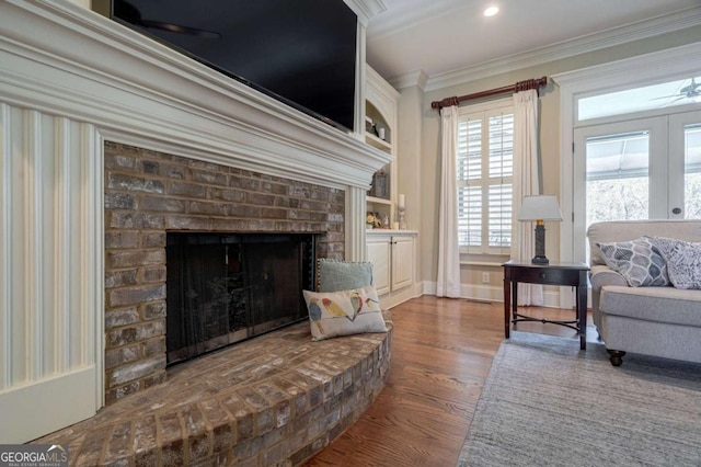 431 Tralee Ct, Statham, GA 30666 - living area featuring ornamental molding, a fireplace, wood finished floors, ceiling fan, and recessed lighting
