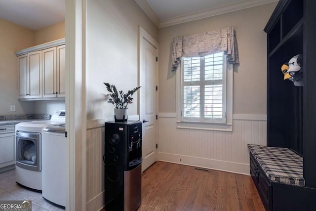 431 Tralee Ct, Statham, GA 30666 - laundry room with cabinet space, washing machine and dryer, wainscoting, light wood finished floors, and ornamental molding