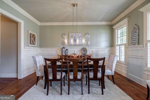 431 Tralee Ct, Statham, GA 30666 - dining space with wood finished floors, crown molding, a chandelier, a wainscoted wall, and a decorative wall