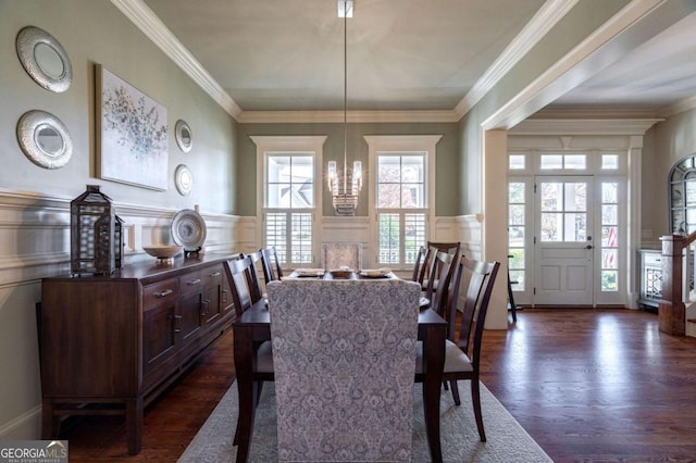 431 Tralee Ct, Statham, GA 30666 - dining area featuring a decorative wall, dark wood finished floors, ornamental molding, and wainscoting