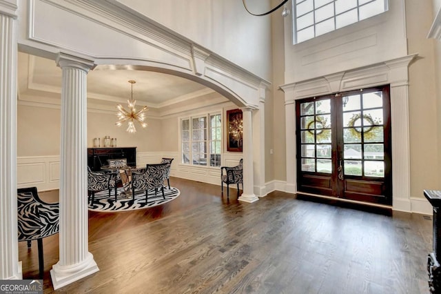 1898 Sam Snead Dr, Braselton, GA 30517 - entrance foyer featuring a decorative wall, ornate columns, arched walkways, and dark wood-type flooring