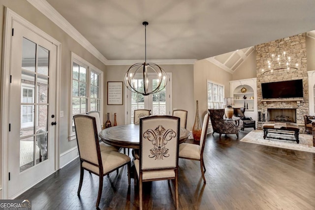 1898 Sam Snead Dr, Braselton, GA 30517 - dining room with baseboards, dark wood finished floors, a stone fireplace, and a chandelier