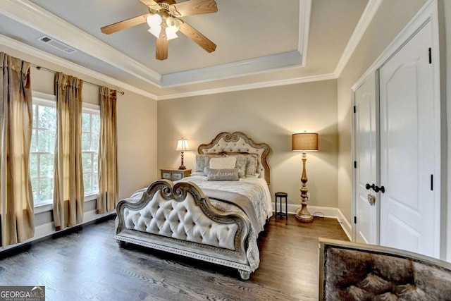 1898 Sam Snead Dr, Braselton, GA 30517 - bedroom featuring a raised ceiling, baseboards, dark wood-type flooring, visible vents, and ornamental molding