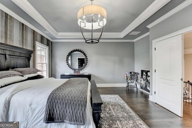 1898 Sam Snead Dr, Braselton, GA 30517 - bedroom featuring a chandelier, a tray ceiling, dark wood finished floors, and baseboards