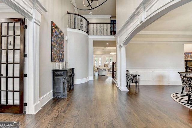 1898 Sam Snead Dr, Braselton, GA 30517 - entrance foyer with crown molding, arched walkways, ornate columns, and wood finished floors