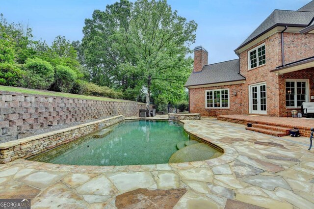 1898 Sam Snead Dr, Braselton, GA 30517 - view of swimming pool with french doors, a fenced backyard, a pool with connected hot tub, and a patio area