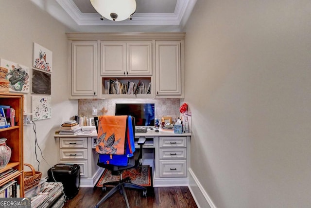 1898 Sam Snead Dr, Braselton, GA 30517 - home office featuring built in desk, dark wood-style floors, ornamental molding, and a raised ceiling