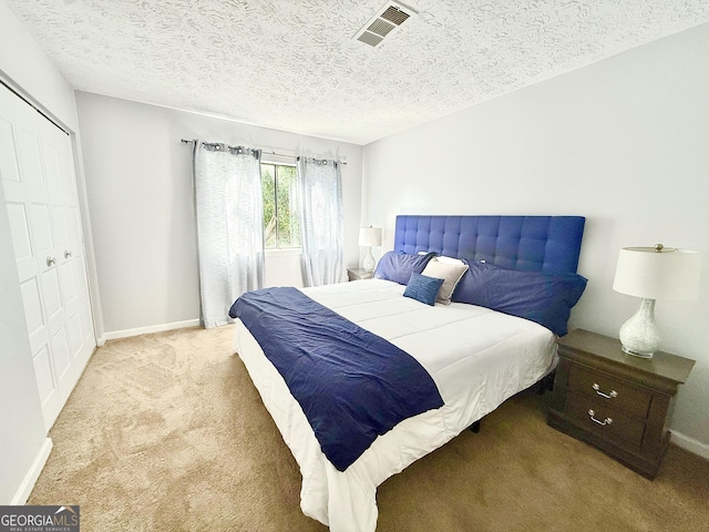 1448 Pine Log Rd NE Unit C, Conyers, GA 30012 - bedroom featuring carpet floors, baseboards, a closet, and a textured ceiling