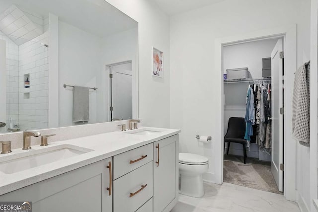 230 New St Unit 2102, Decatur, GA 30030 - full bathroom featuring double vanity, marble look tiles, a spacious closet, and a tile shower