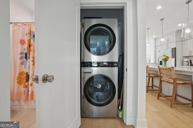 230 New St Unit 2102, Decatur, GA 30030 - laundry area with estacked washer and dryer and light wood-style flooring