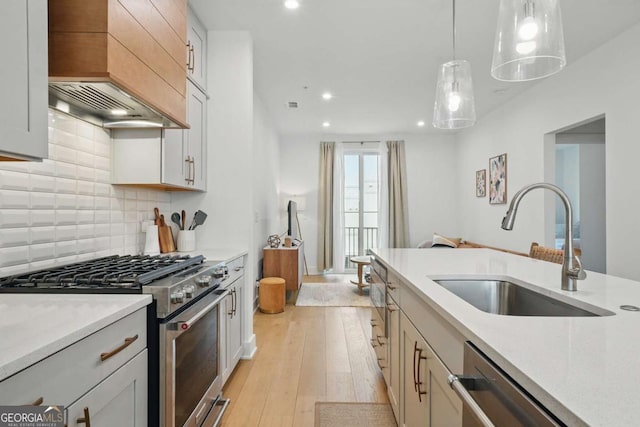 230 New St Unit 2102, Decatur, GA 30030 - kitchen with stainless steel appliances, recessed lighting, light wood-type flooring, backsplash, and hanging light fixtures