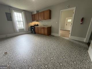kitchen featuring brown cabinetry and baseboards
