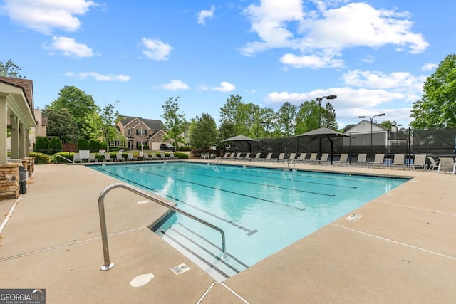 pool featuring a patio and fence