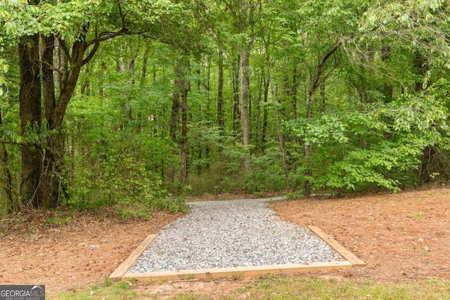 exterior space featuring a forest view