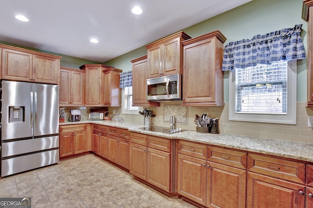 201 Drews Ridge Dr, Newnan, GA 30263 - kitchen with appliances with stainless steel finishes, light stone countertops, backsplash, recessed lighting, and brown cabinetry