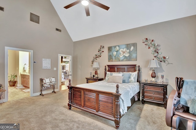 bedroom with visible vents, baseboards, high vaulted ceiling, light colored carpet, and connected bathroom