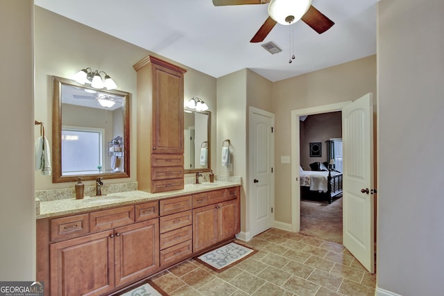 bathroom featuring visible vents, a sink, baseboards, and ceiling fan