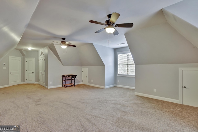 additional living space featuring baseboards, a ceiling fan, lofted ceiling, and light carpet