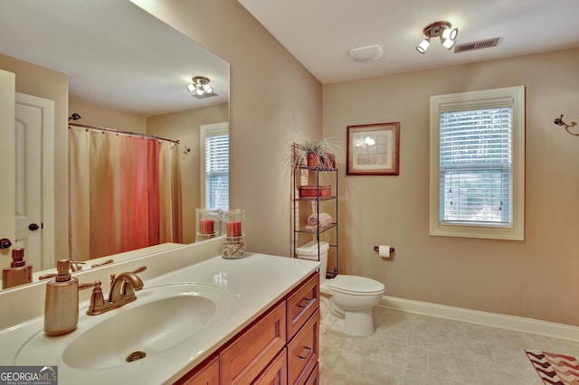 bathroom featuring visible vents, tile patterned floors, baseboards, vanity, and toilet